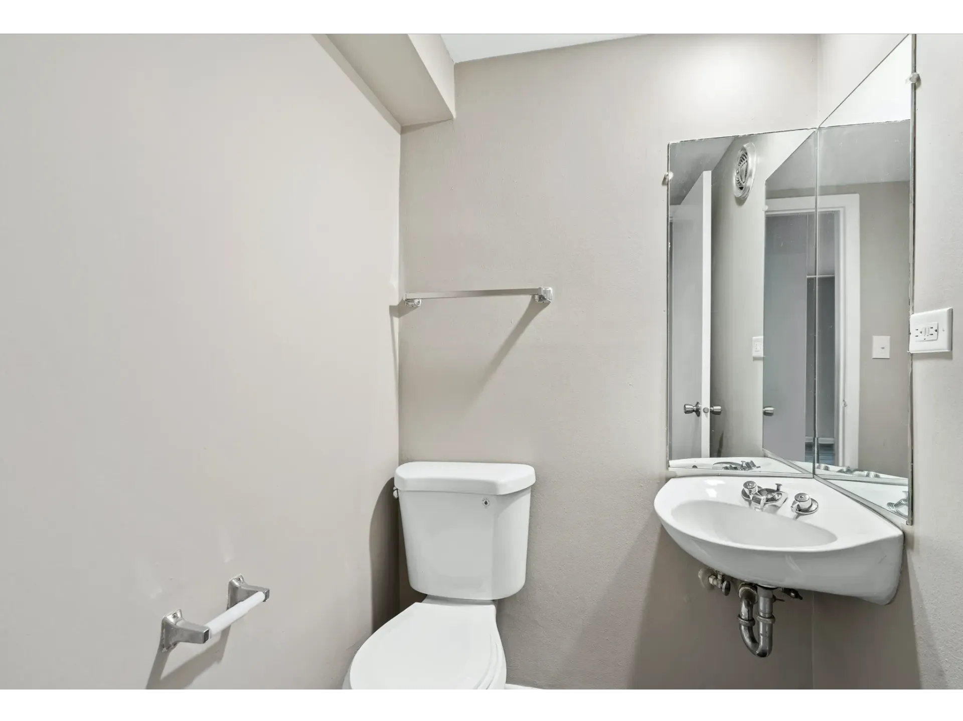 Interior view of a small bathroom with toilet and sink.