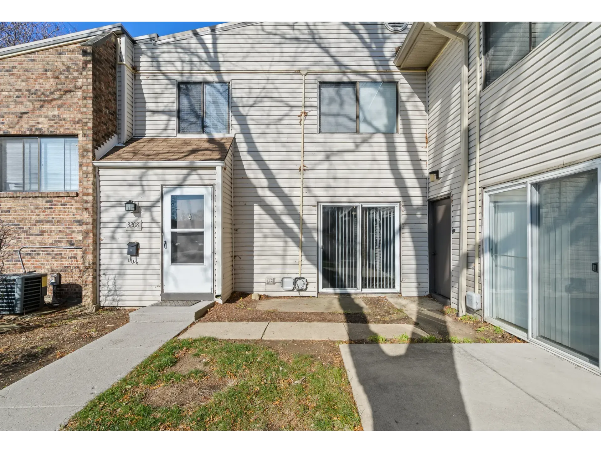 Exterior view of an apartment entrance with a door and windows.