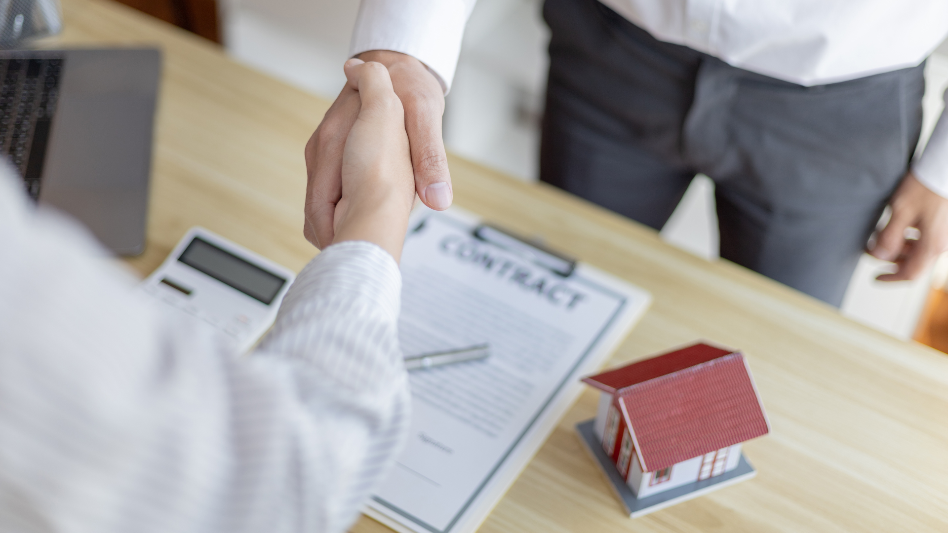 Island Coast Mortgage storefront with a white car parked nearby.