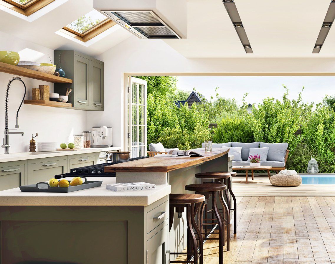 A kitchen with a large island and stools and a view of a swimming pool.