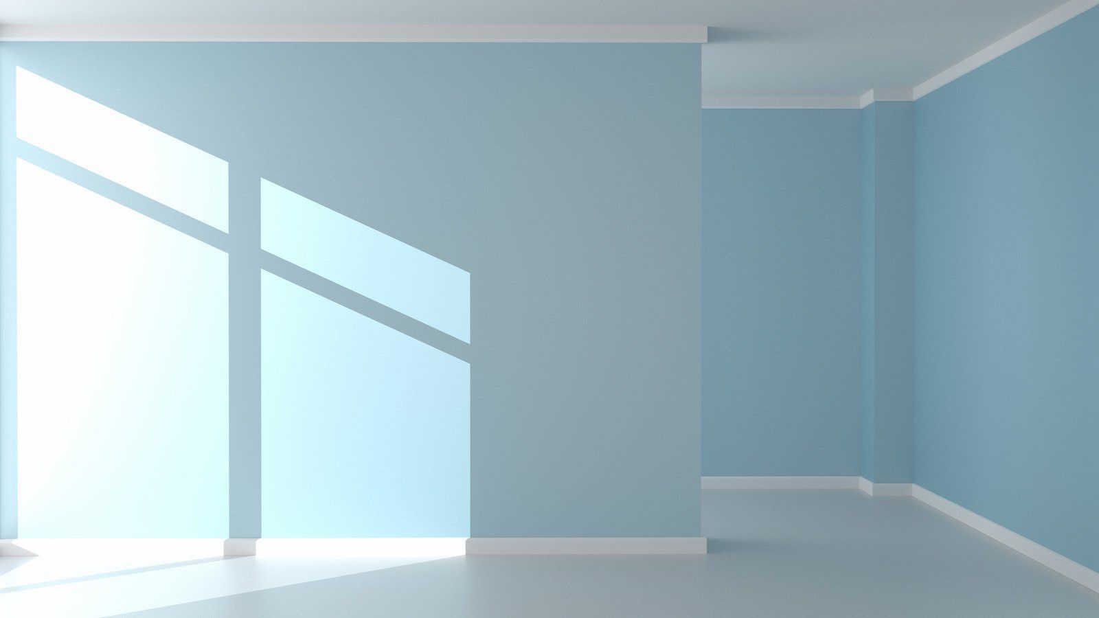 Empty room with light blue walls and white trim, sunlight shining through a window.