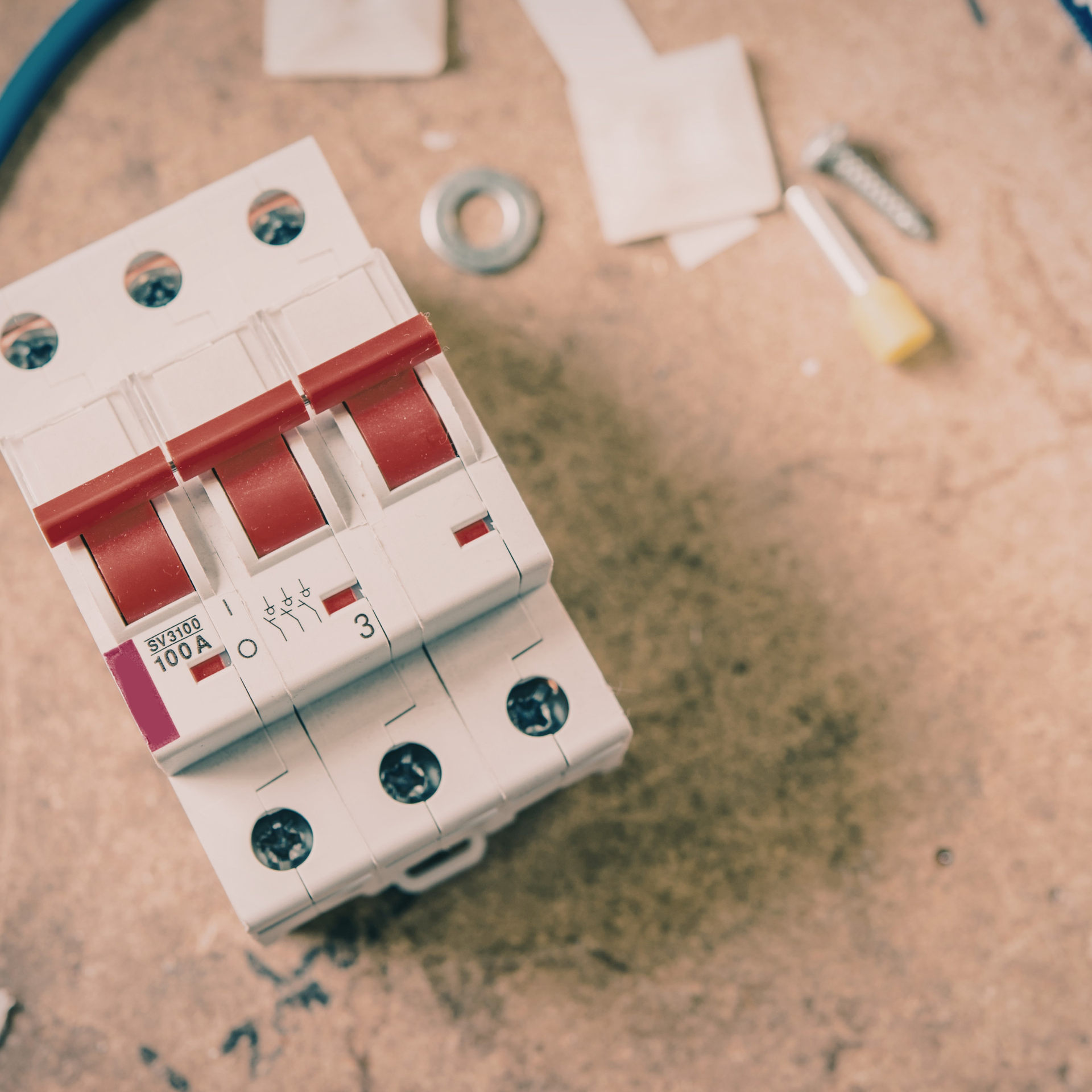 Air conditioning units with toolbox and gloves in backyard.