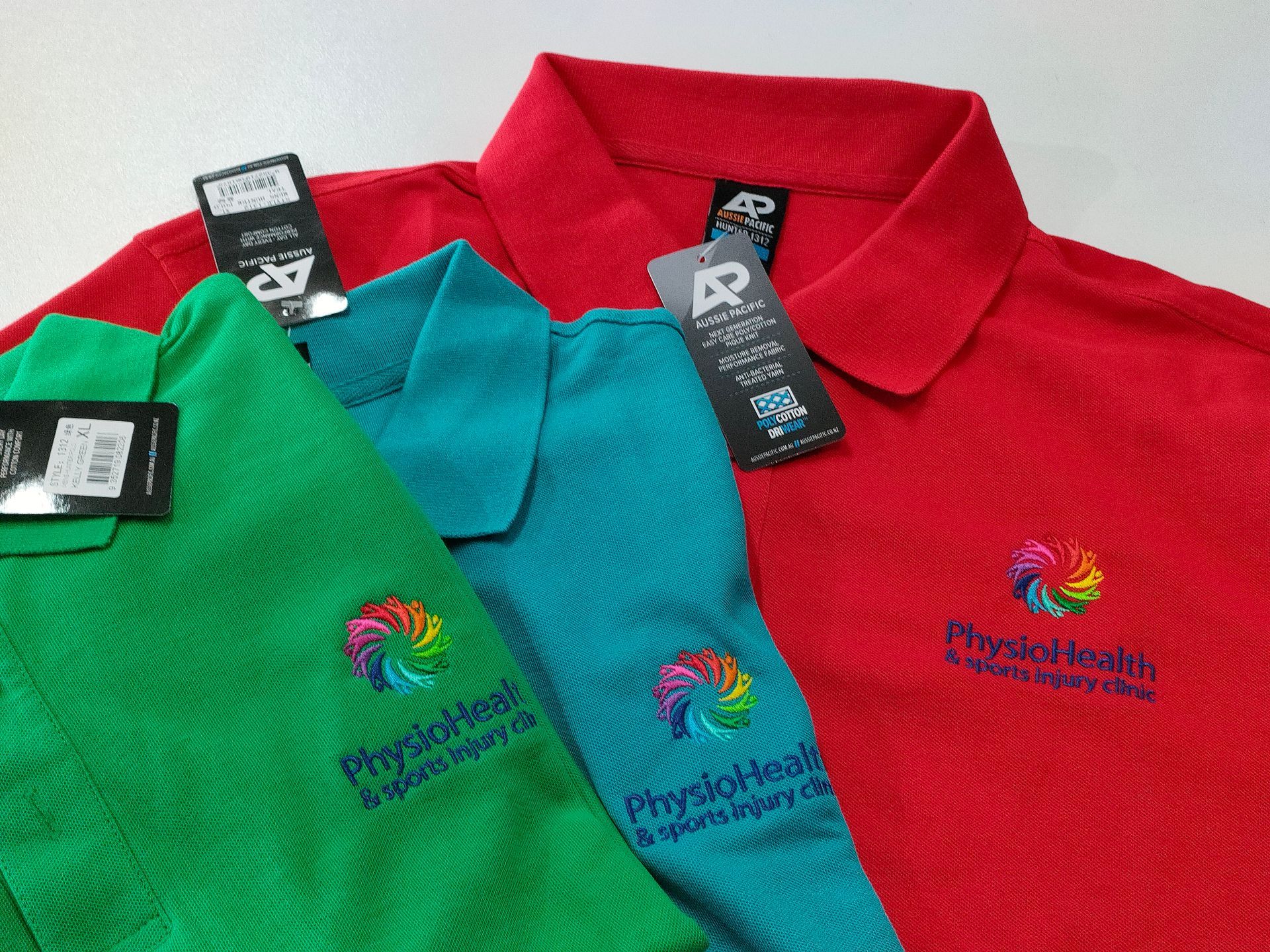 Three Physiotherapy Shirts In Green, Blue And Red — NMTG Embroidery In Wollongong, NSW