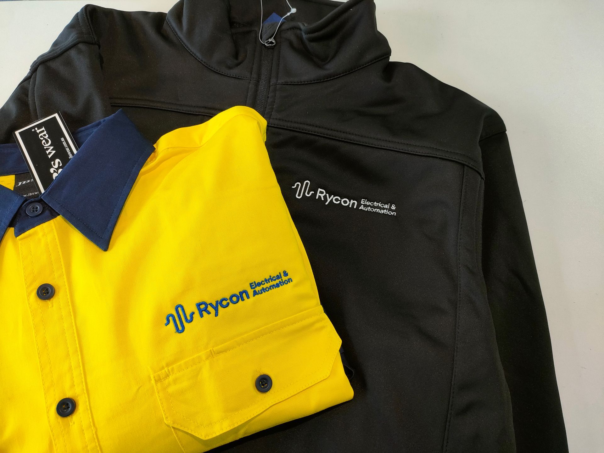 A Yellow Button Up Shirt And Black Jacket — NMTG Embroidery In Wollongong, NSW