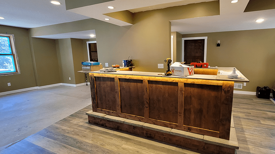 A kitchen with a large wooden island in the middle of the room.