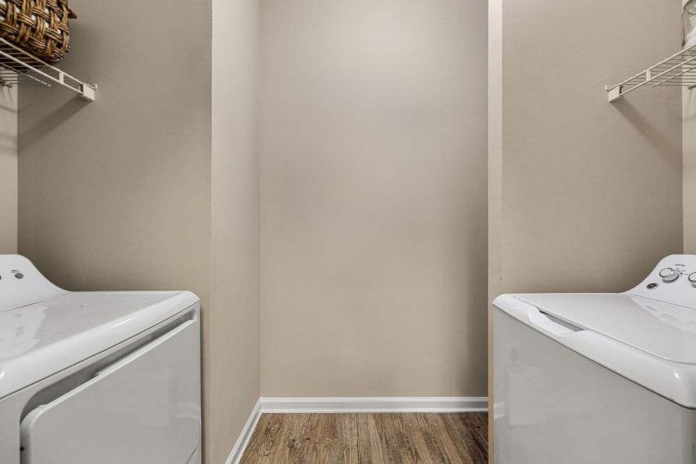 A laundry room with a washers and dryer at Marquis at Sugarloaf, offers Duluth apartments for rent.