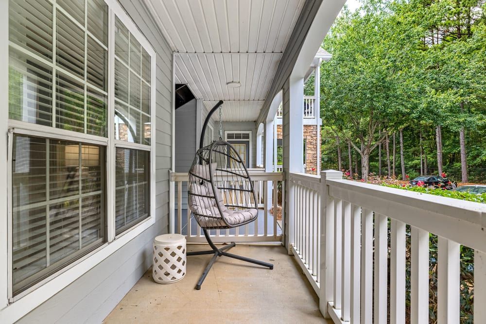 A hanging chair on the balcony at Marquis at Sugarloaf, offers apartments for rent near Gwinnett Medical Center.