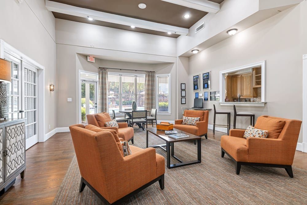 Spacious clubhouse filled with furniture and a couch at Marquis at Sugarloaf, offers apartments for rent near Sugarloaf Mills in Duluth, GA.