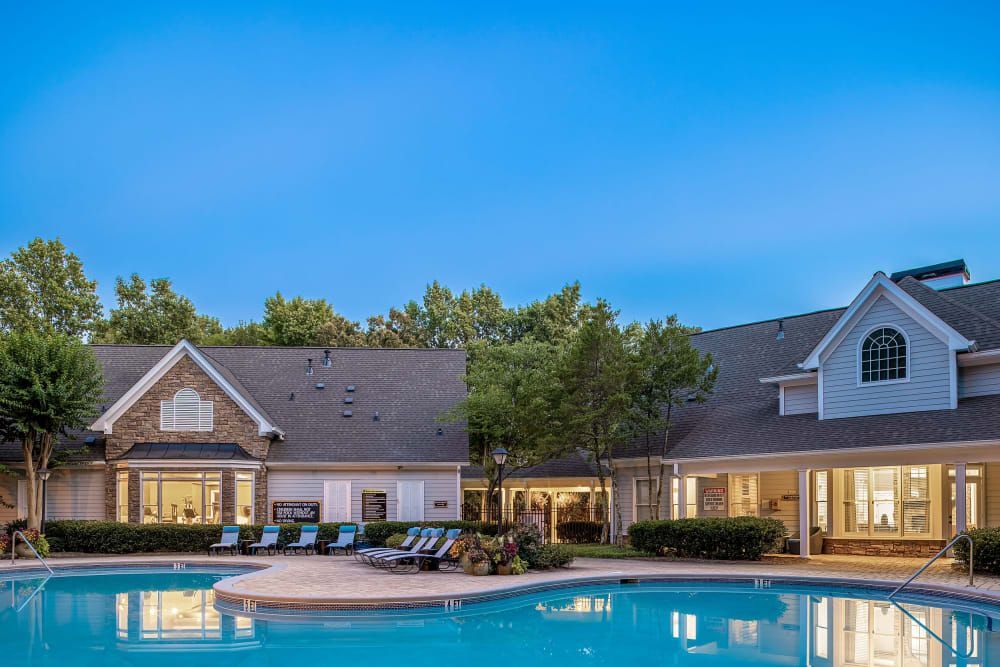 A large swimming pool in front of the clubhouse at Marquis at Sugarloaf in Duluth, GA.
