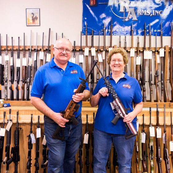 a man and women holding firearms 