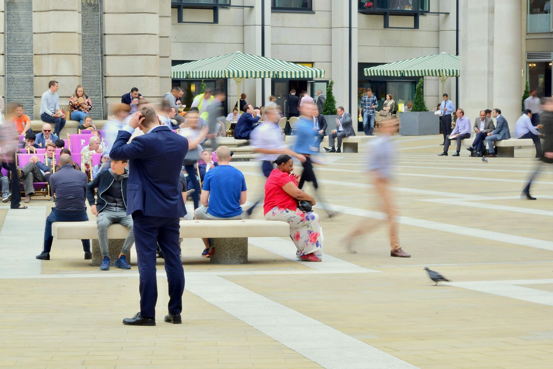 A man in a suit is taking a picture of a crowd of people.