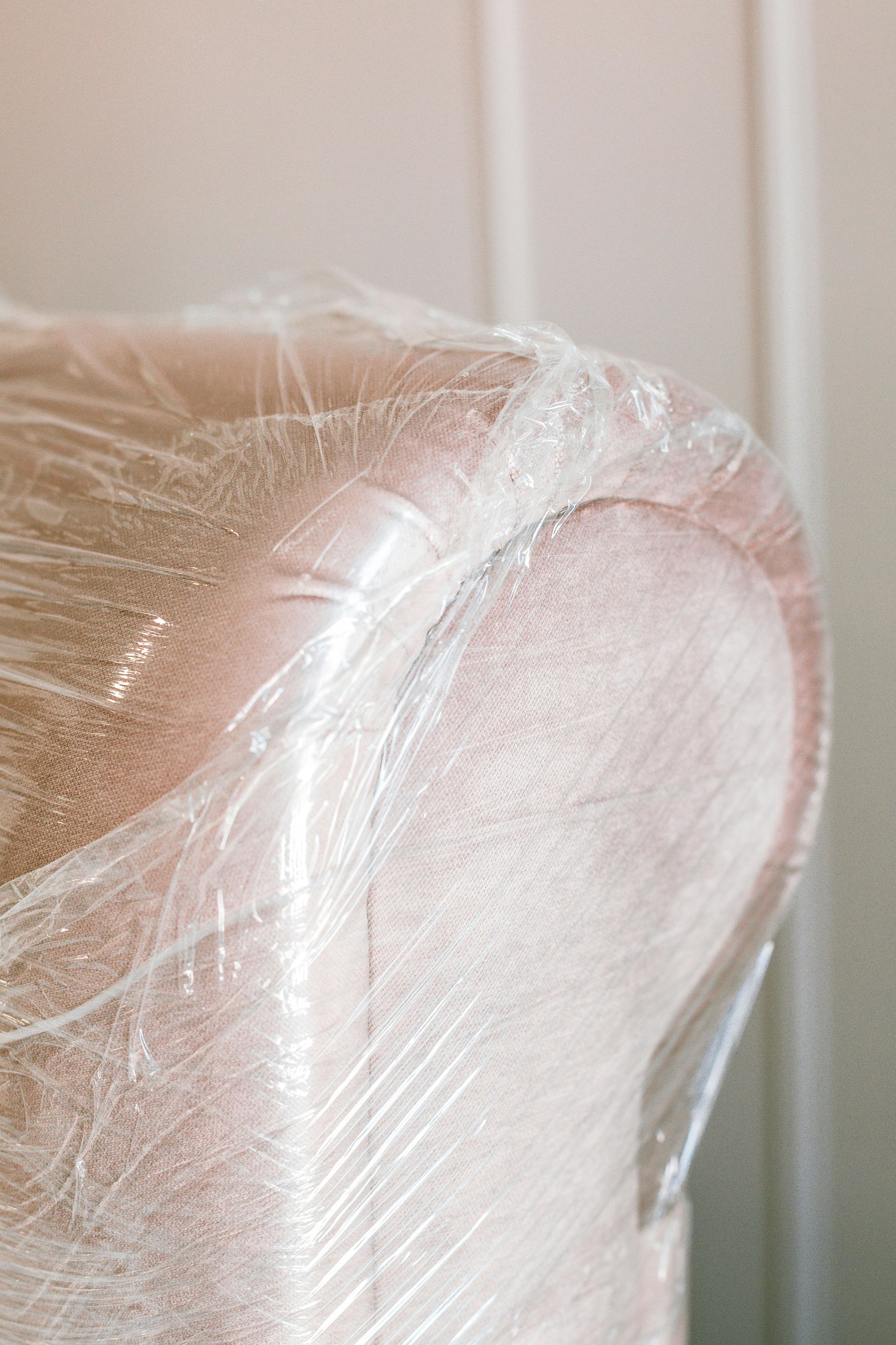 A close up of a piece of furniture wrapped in plastic wrap.