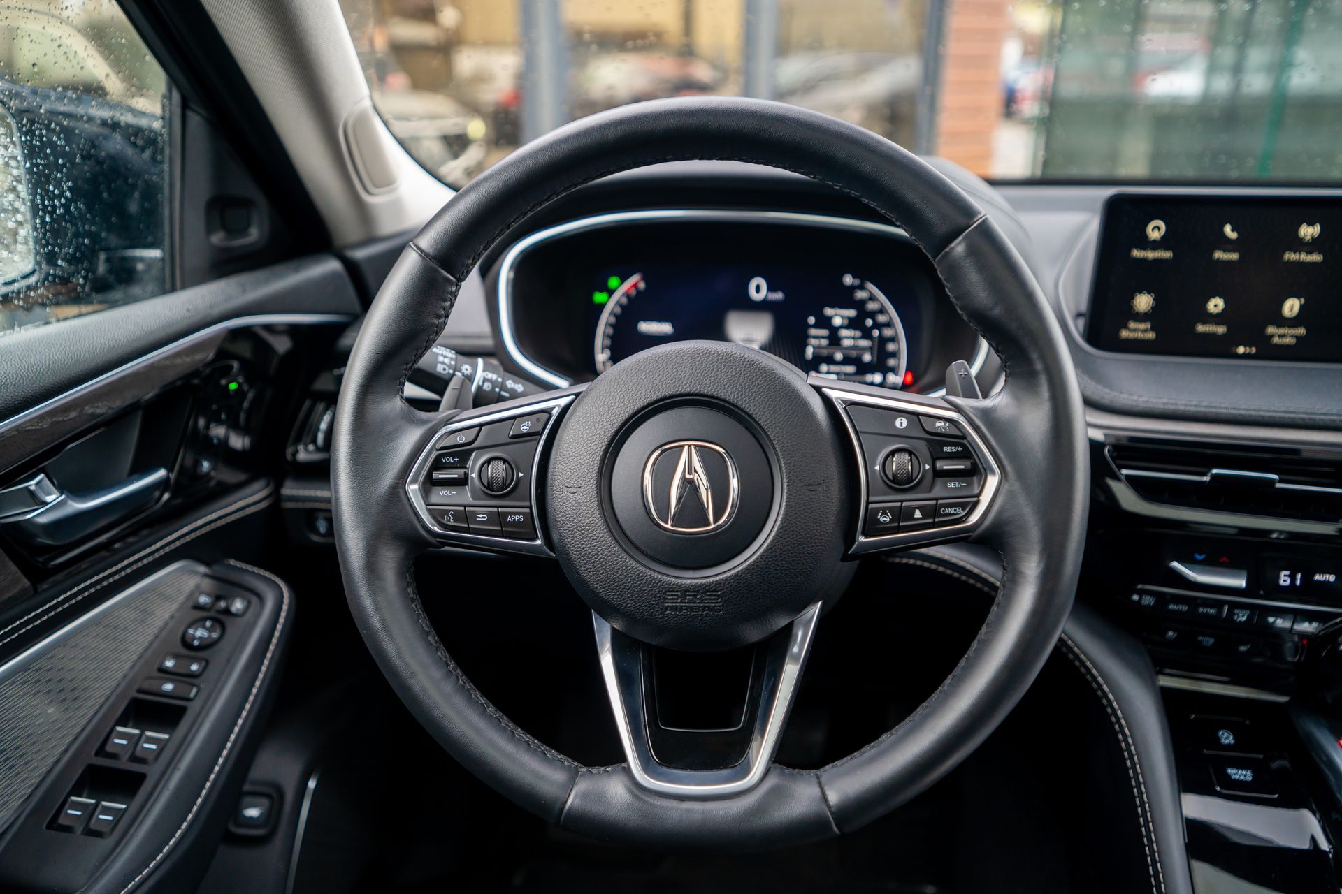 Acura steering wheel and dashboard interior with digital gauges and center touchscreen view