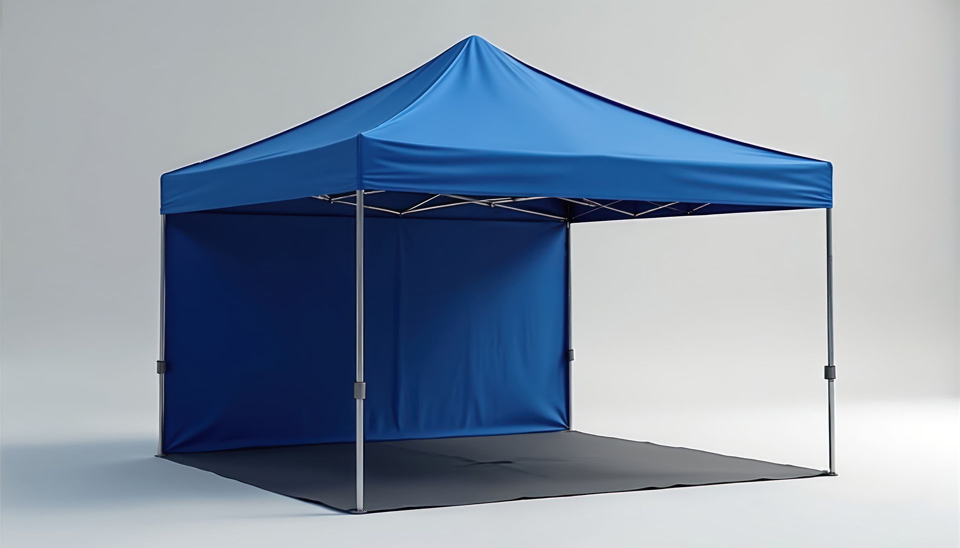 Blue pop-up canopy tent with sidewall on a gray floor against a plain background