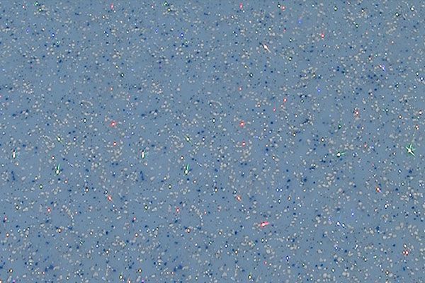 Blue speckled textured surface with small multicolored flecks