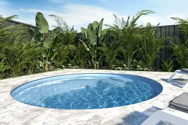 Small round pool with blue water in a tropical backyard, surrounded by palm plants and lounge chairs
