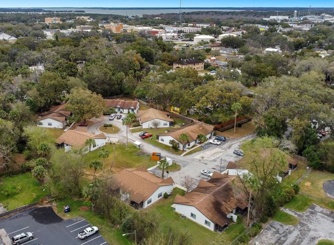 An aerial view of a residential area with lots of trees and buildings.