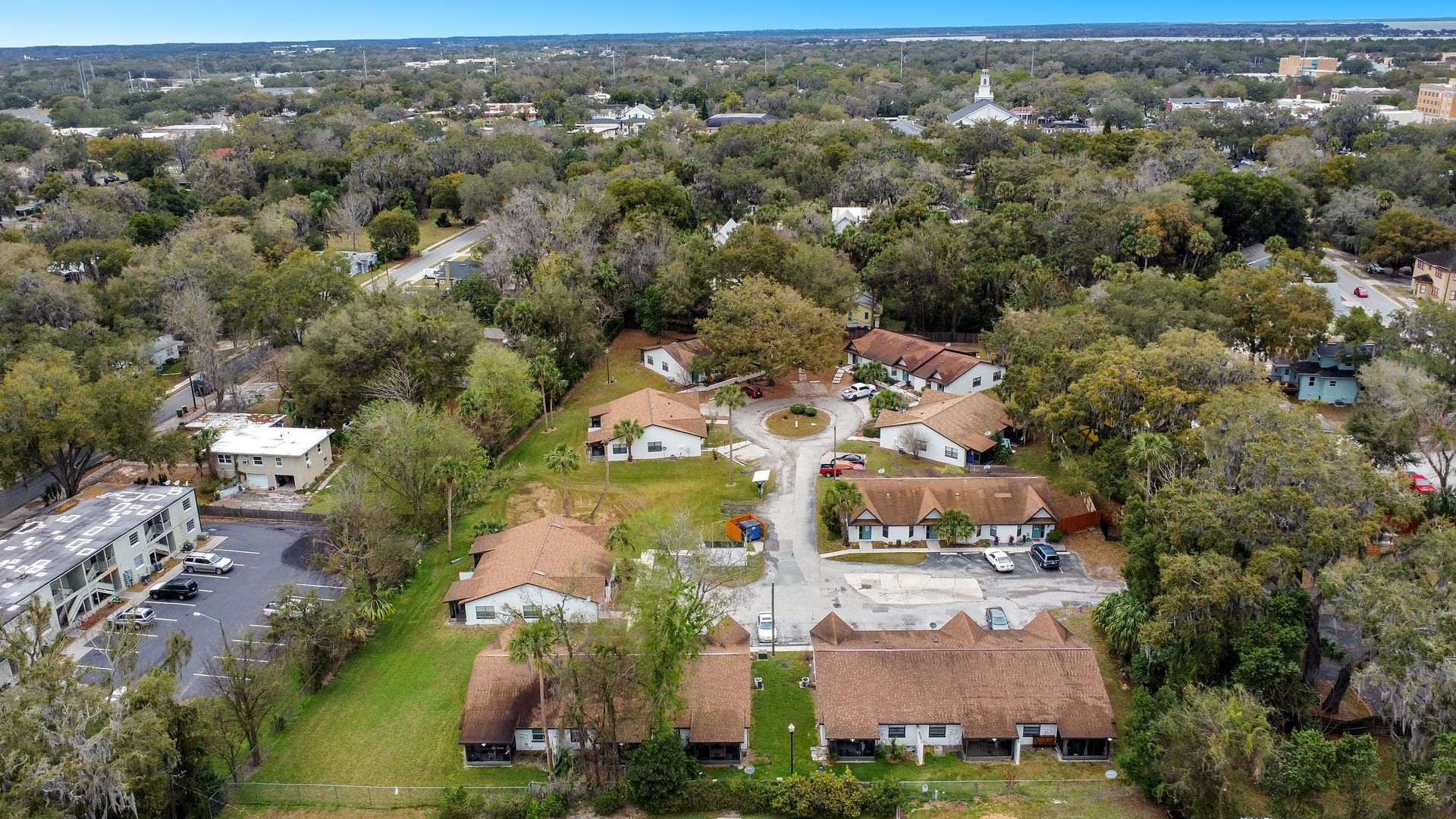 An aerial view of a residential area with lots of trees and buildings.