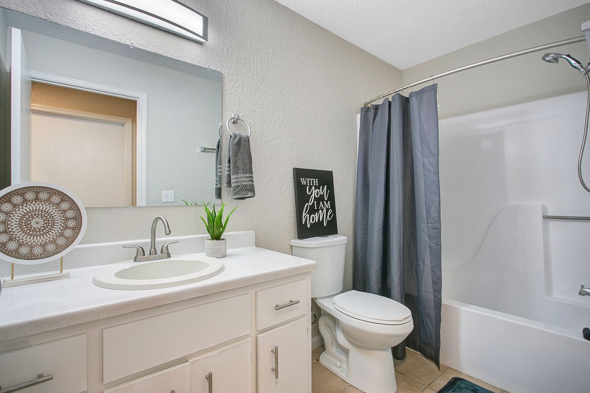 A bathroom with a sink, toilet, shower and bathtub.