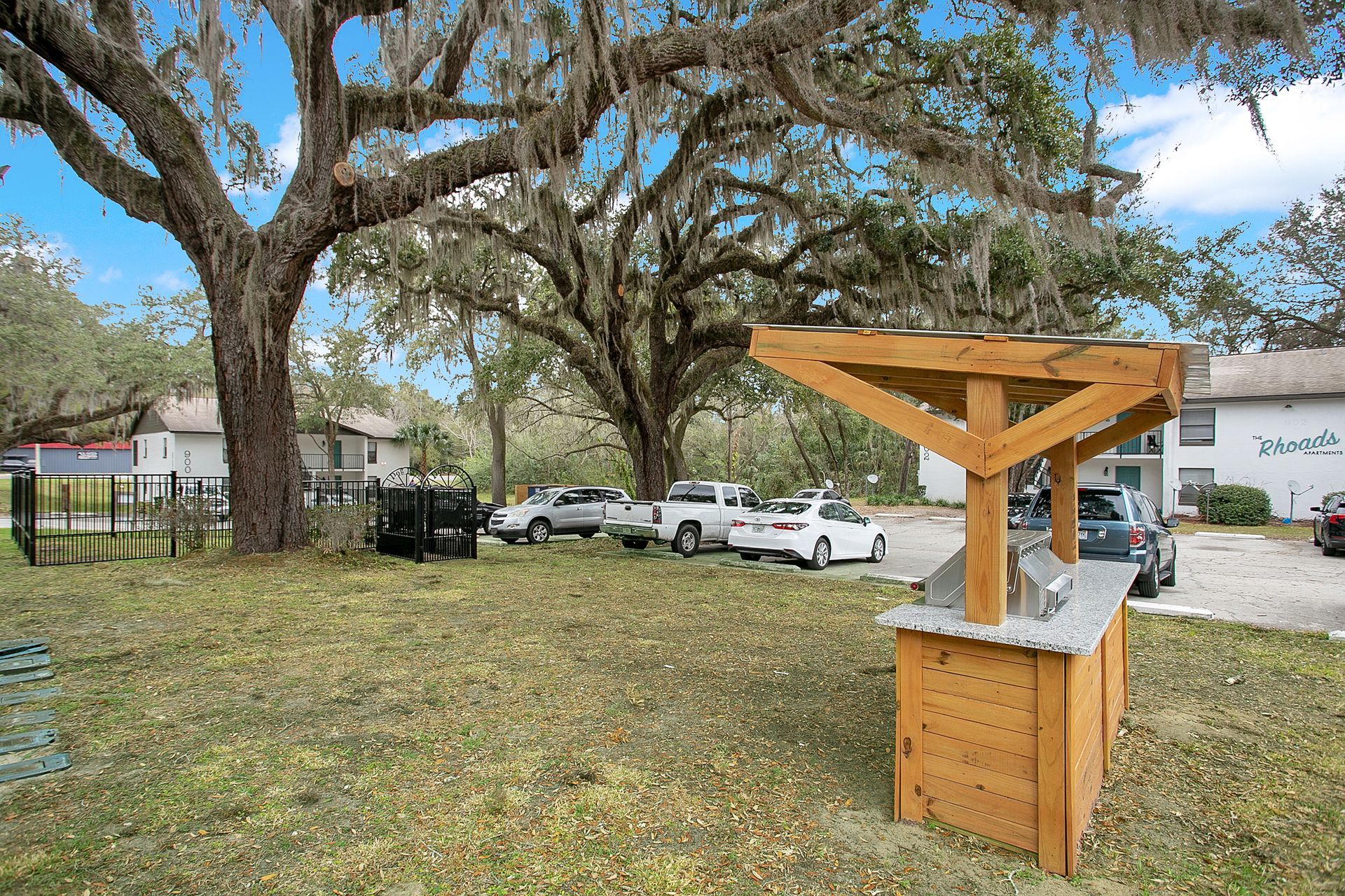 A wooden structure is sitting in the middle of a grassy field.