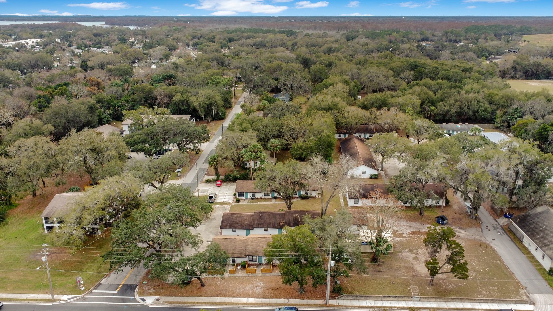 An aerial view of a residential area with lots of trees and apartment buildings.