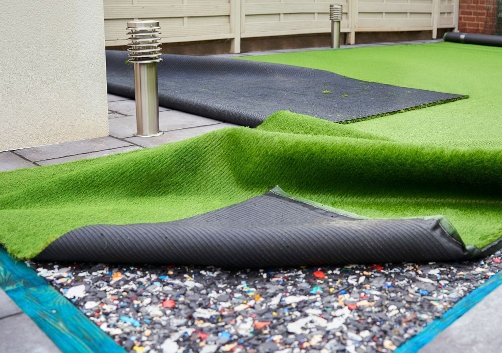 Zest Artificial Grass Luton artificial lawn being installed with play area shock absorbing padding for a school