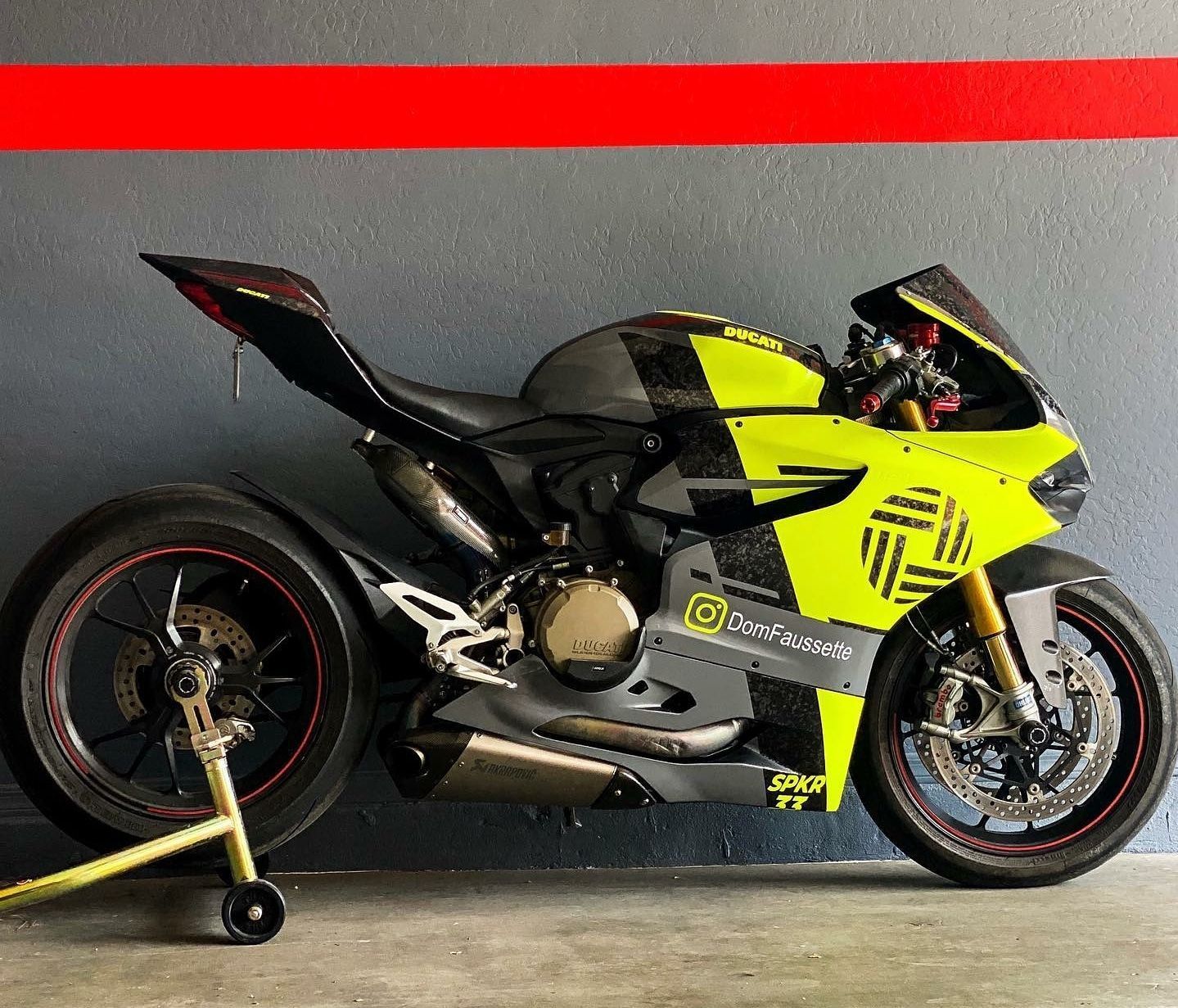 A black and gold car is parked in a garage.