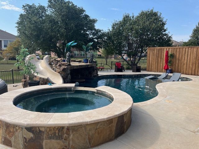 Backyard pool with spa, waterslide, and patio furniture.