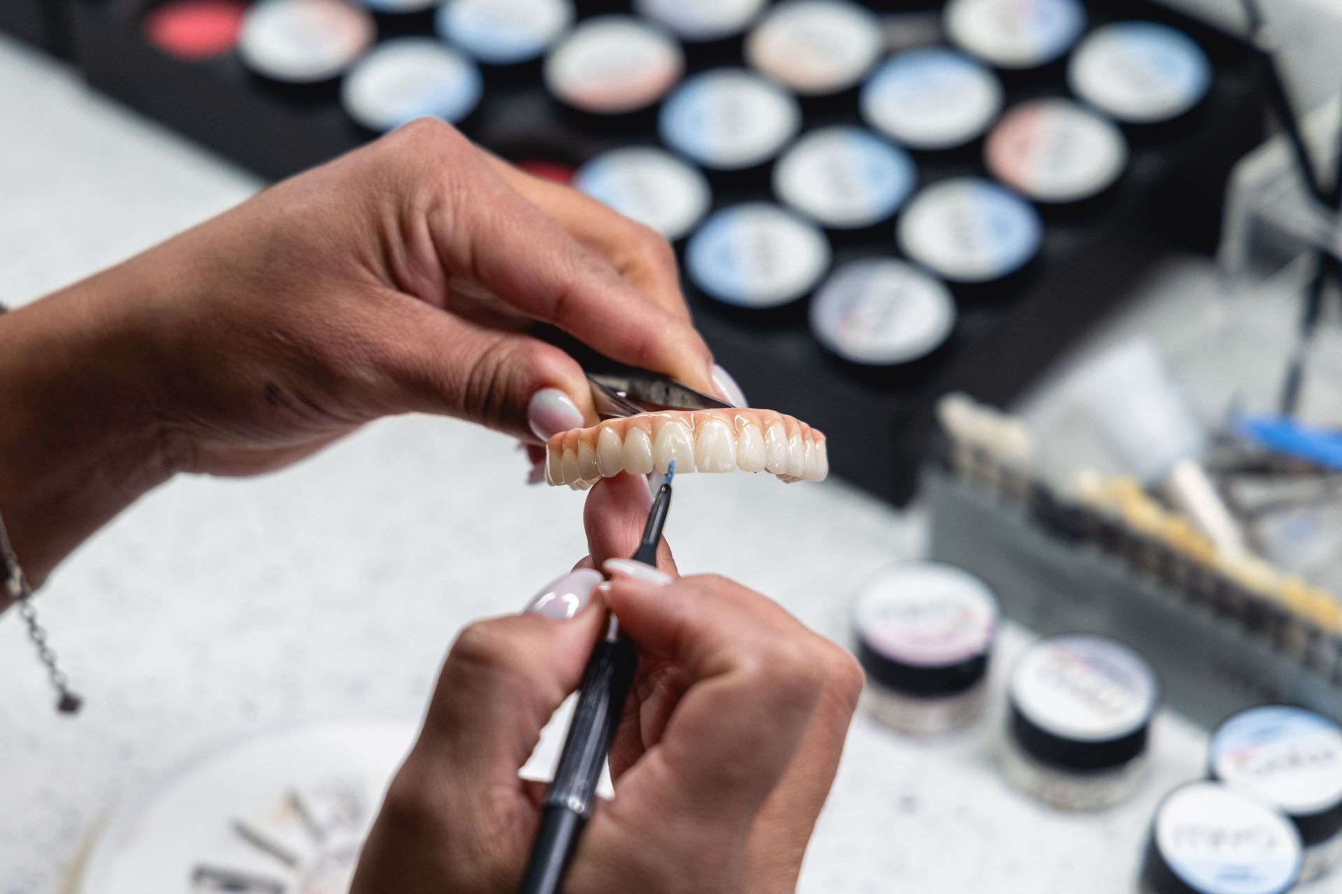 An image of artificial teeth being painted