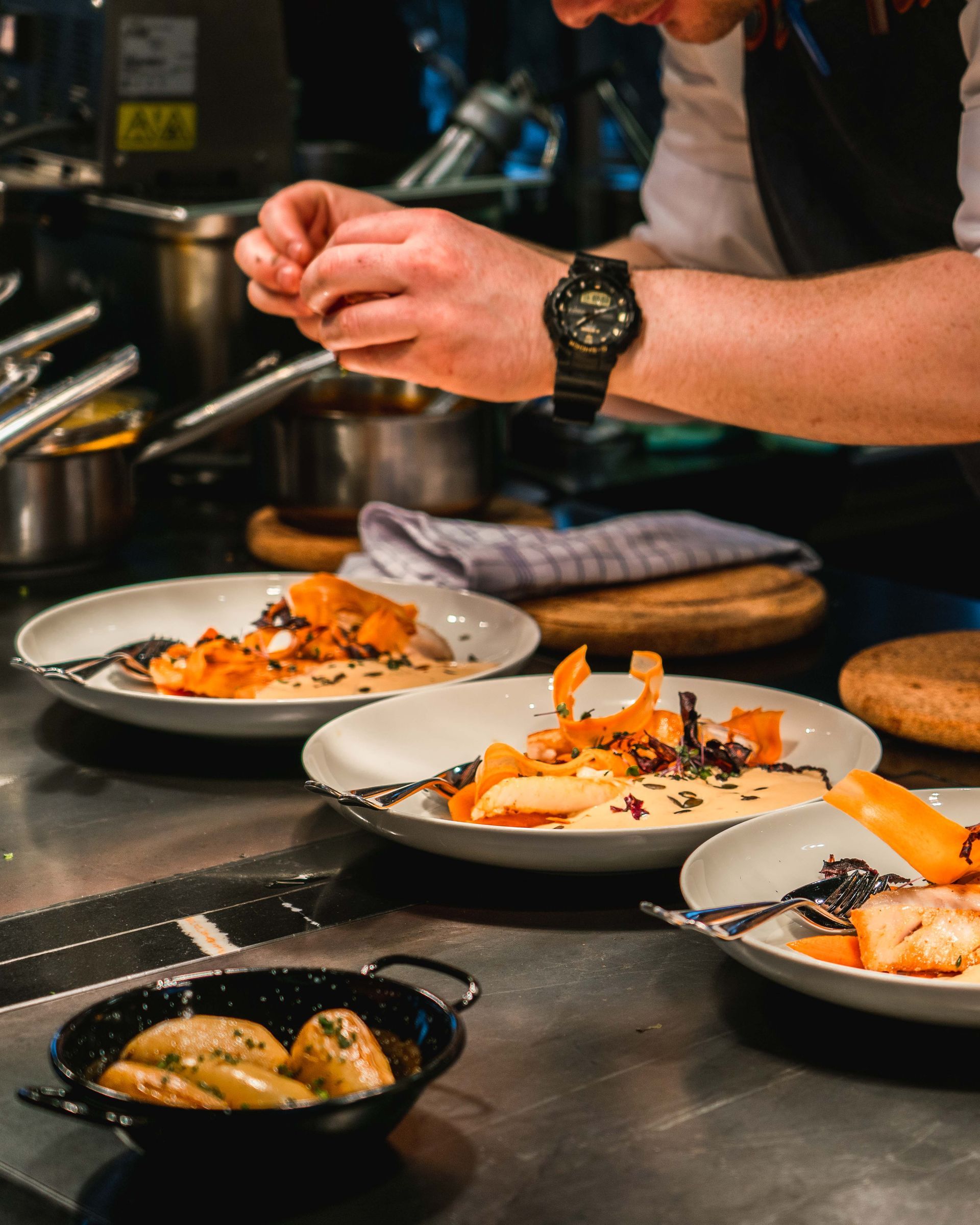 Creamy seafood soup in a blue and white bowl, drizzled with olive oil, on a wooden table.