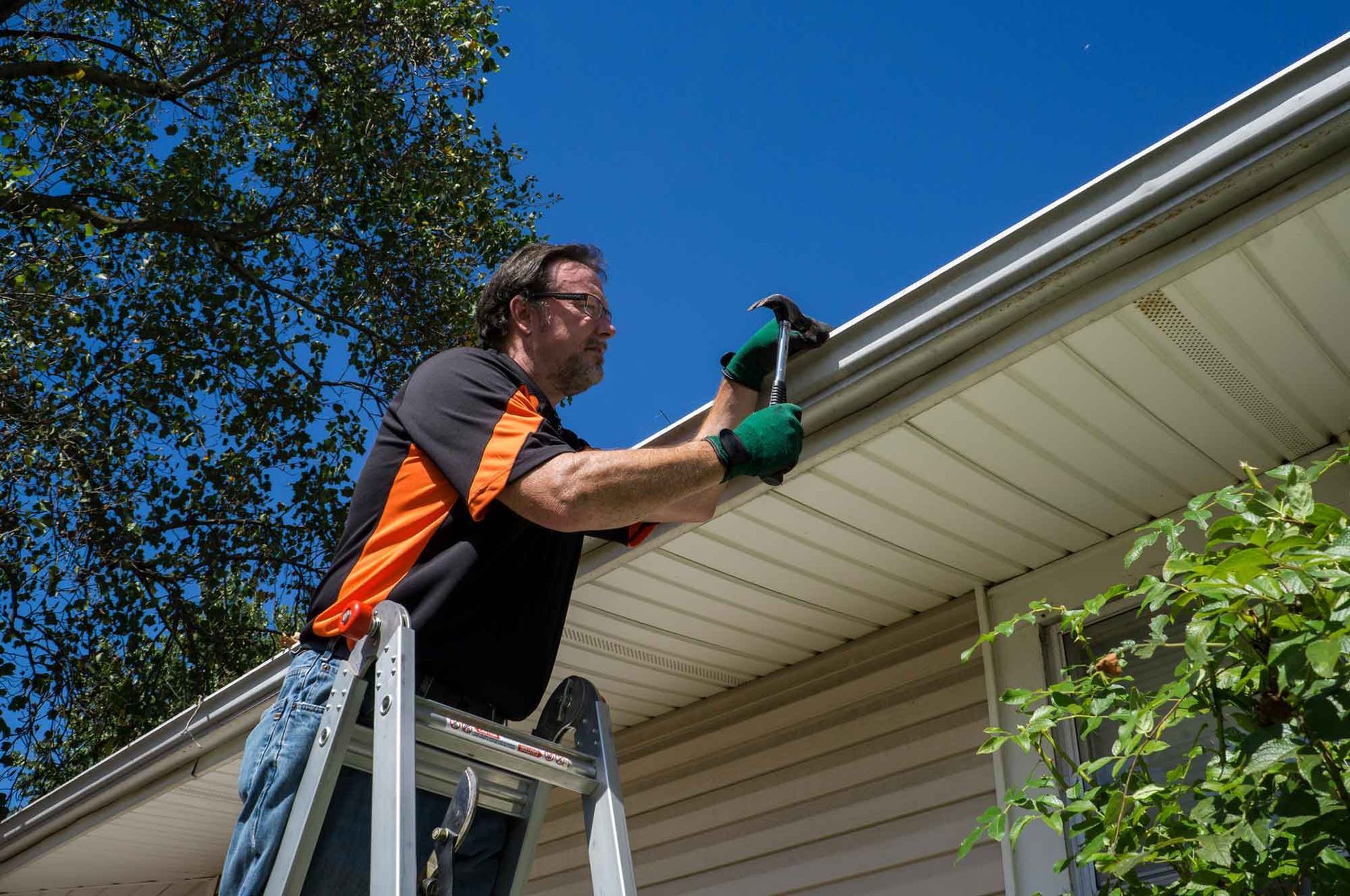 Man Repairing House Gutter — Ashland, MA — Gutter Pal
