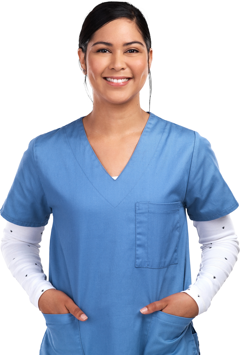 Woman in blue scrubs smiles, hands in pockets.