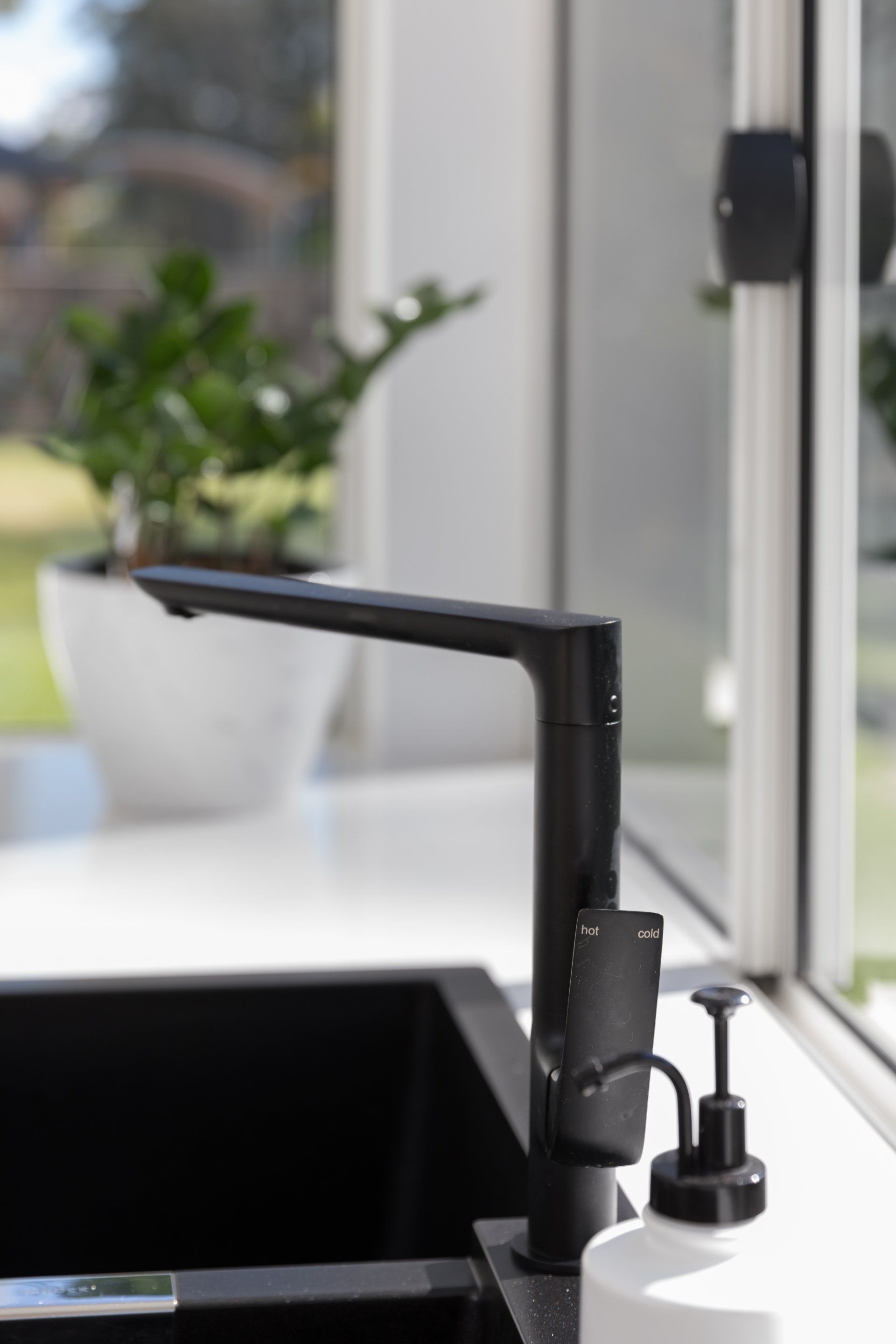 Close Up View Of Black Kitchen Sink And Tap — Platinum Kitchens & Bathrooms In Coffs Harbour NSW