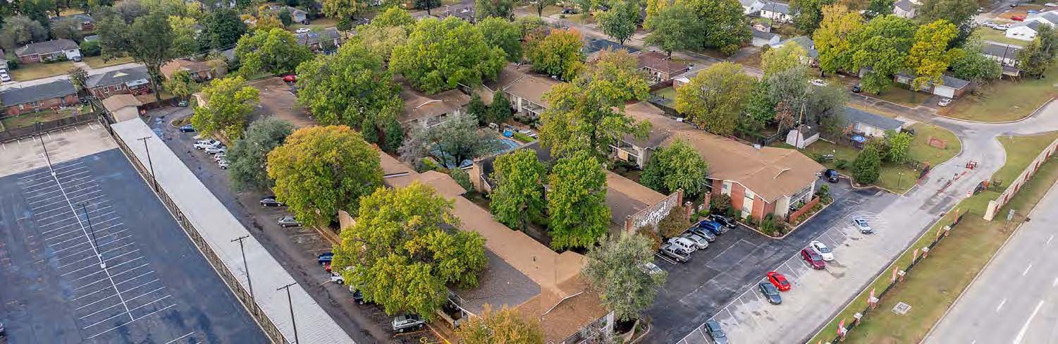 An aerial view of a residential area with lots of trees and buildings.