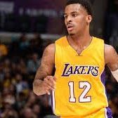 Basketball player in a yellow Lakers jersey with the number 12, running on the court.