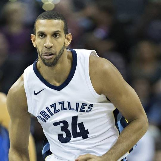 Basketball player wearing a Grizzlies jersey (#34), looking forward with a serious expression.