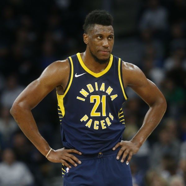 Indiana Pacers player, number 21, stands with hands on hips, wearing a navy blue jersey.