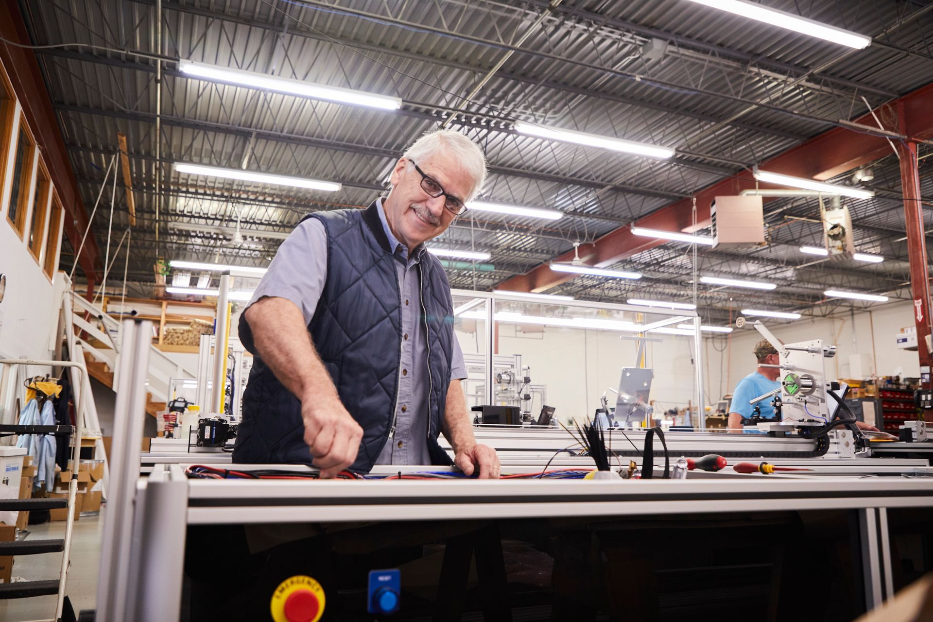 A man is working on a machine in a factory.