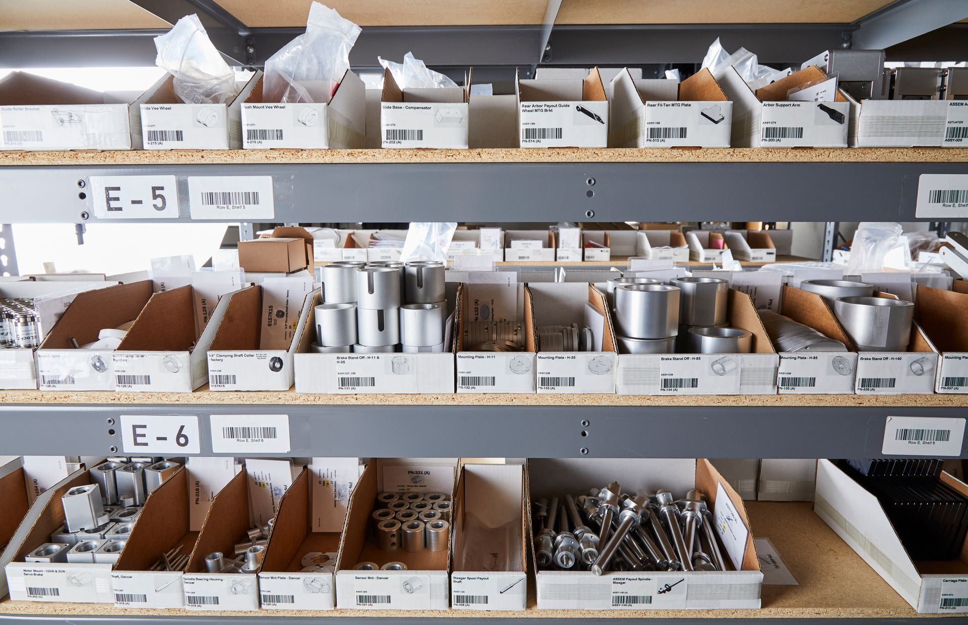 A warehouse shelf with boxes labeled e-5 and e-6