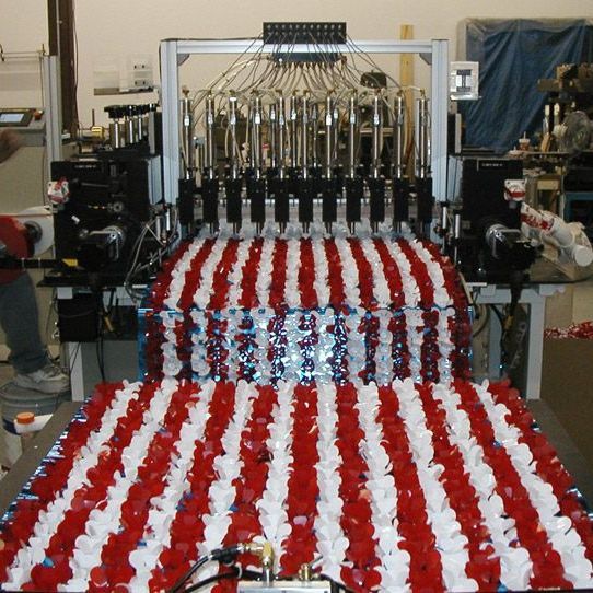 A machine is making a red white and blue striped flag rothgreaves custom manufacturing