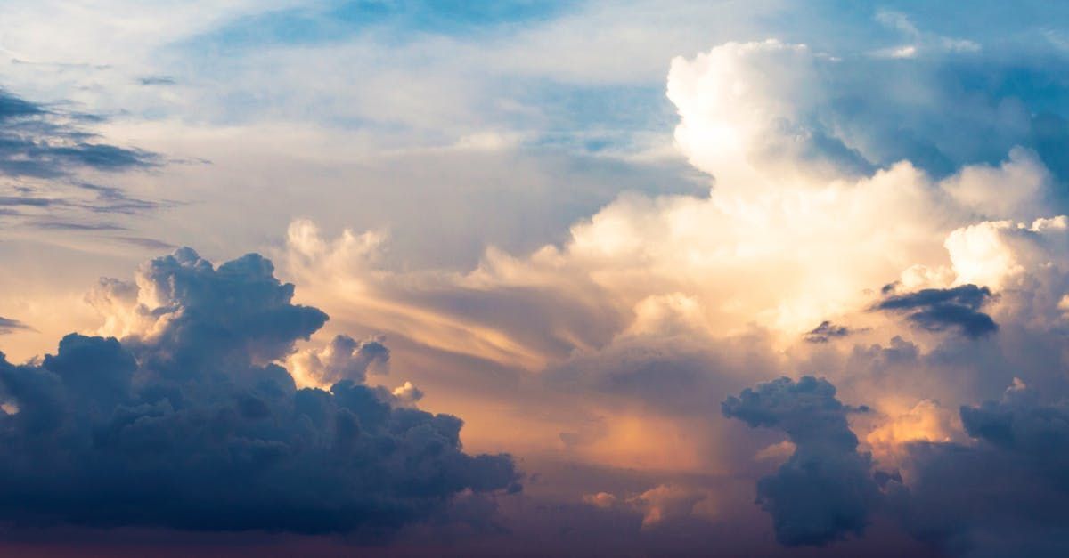 The sun is shining through the clouds in the sky.