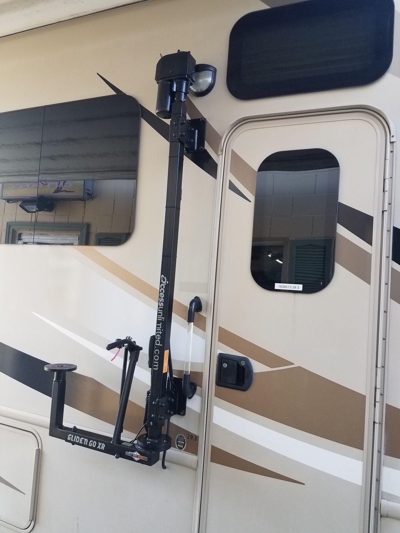A bicycle rack is attached to the side of a rv.