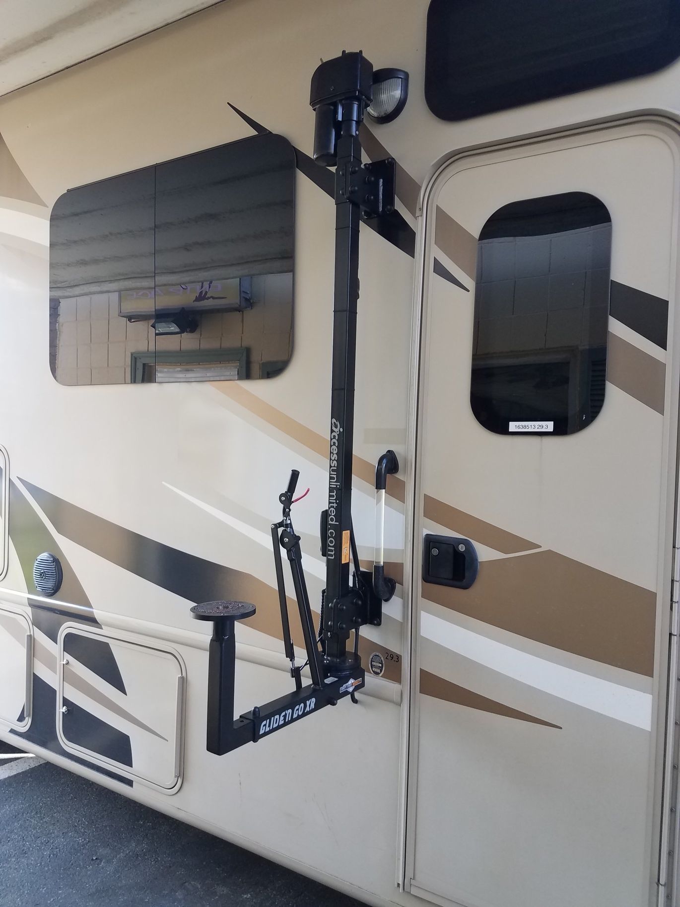 A rv with a bike rack attached to the side of it