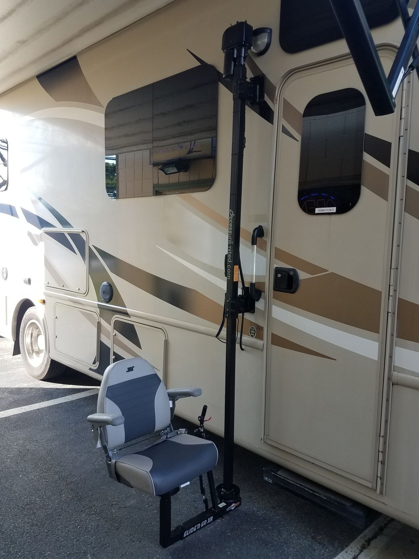A chair is attached to the side of a rv.