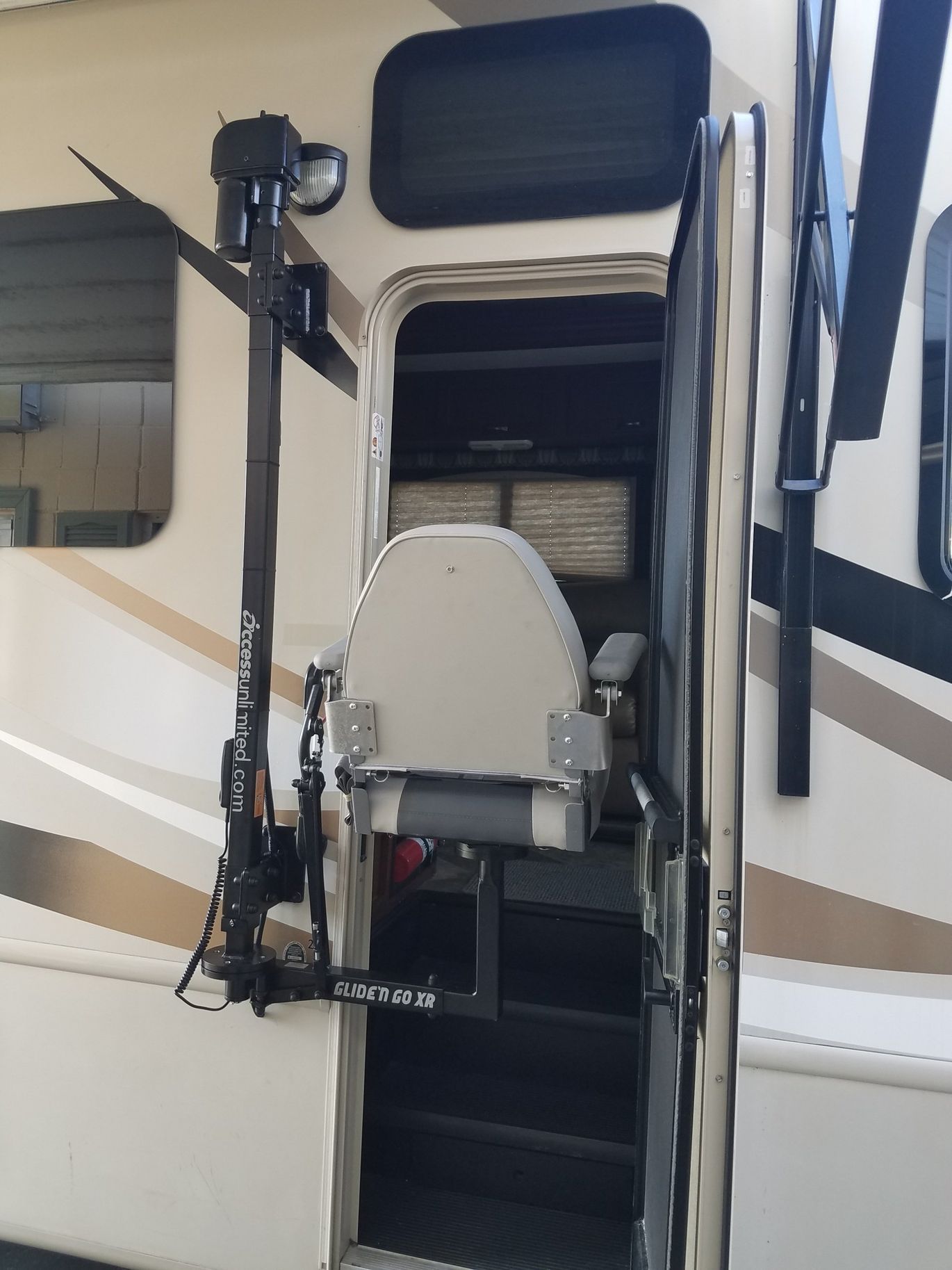 A chair is attached to the side of a rv