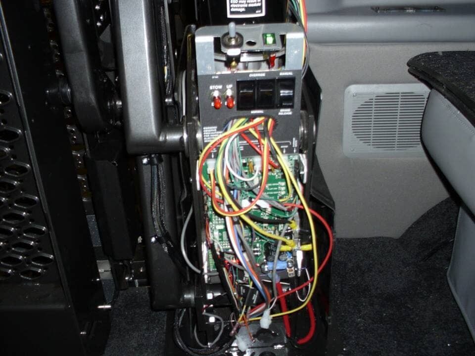 A bunch of wires are connected to a device in a car