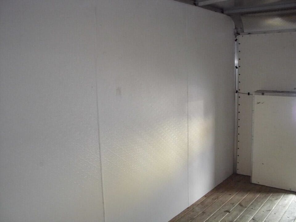 A room with a wooden floor and white walls.