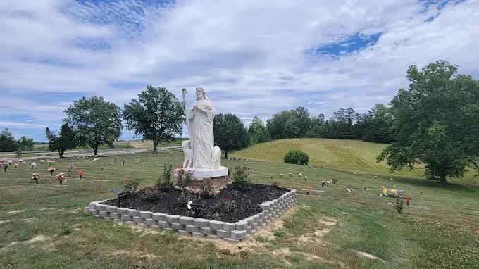 The front door of a house with a porch and plants in front of it.