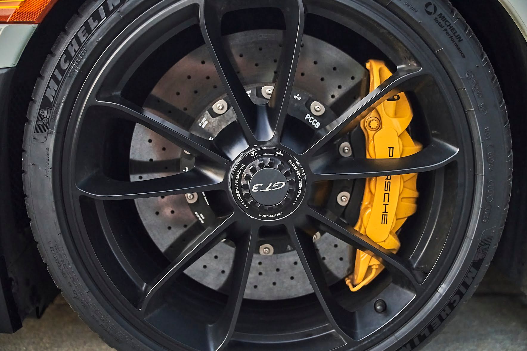 A close up of a car wheel with a michelin tire