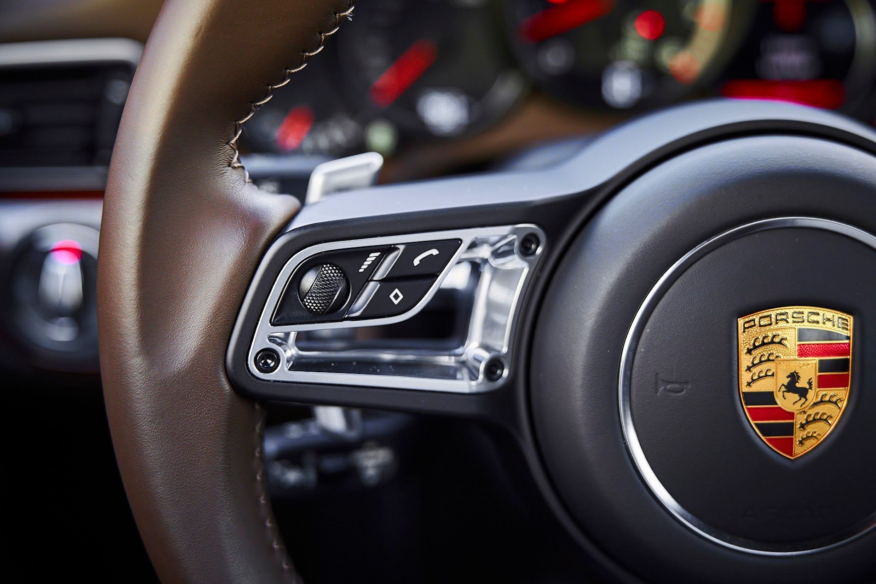 A close up of a porsche steering wheel